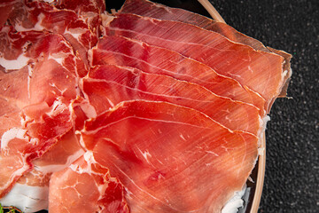 Jamon meat iberico or serrano snack aperitif fresh tasty food dish gourmet food background on the...