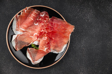 Jamon meat iberico or serrano snack aperitif fresh tasty food dish gourmet food background on the table rustic food top view copy space