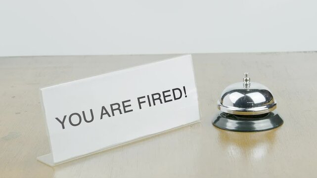 You Are Fired Office or Room with Hand Ringing The Bell on Desk or Table Multiple Times