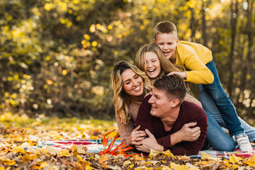 Family Playing In Park On Autumn Day