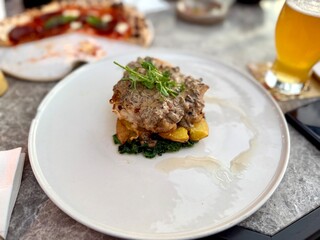 Fine dining grilled chicken thigh served with potatoes, spinach and chard