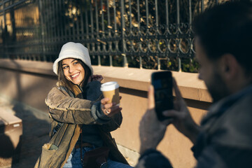 Smiling Woman in Winter Outfit Being Photographed