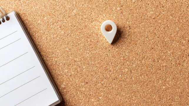 Corkboard with white push pin and notebook