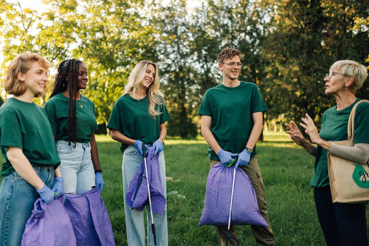 Group of volunteers collecting garbage in park