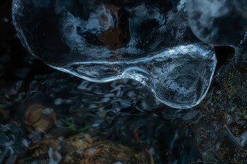 A stream running through a frozen coniferous forest, a world of ice and snow, Norway, Macro