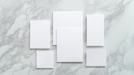 Group of five blank white cards arranged in a horizontal line on a white marble surface.