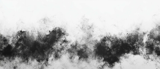 Black ink diffusion with blurred edges on a white background creating abstract texture
