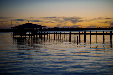 Fototapeta premium Silhouette pier at sunset in Arica Bay Alabama USA