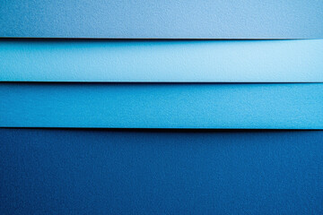Four different layers of blue paper, abstract background with blue horizontal paper stripes