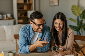 Modern living. Couple balancing their budget in a stylish, airy interior