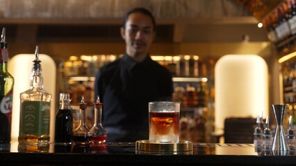 Focusing in serving mist smoky classical mixing whiskey cocktail presentation cooling textured, recommending special welcome tasty creative by bartender background at beverage counter bar. Vinosity.