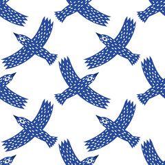A fun folk seamless pattern with blue birds. A boho print with simple flying crows.