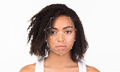 A young individual showing a neutral expression as facial recognition technology analyzes their...