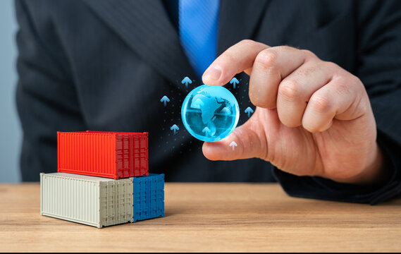 Businessman holding globe of planet Earth over stack of shipping containers. World trade and economic processes. Globalization. Import, export, transportation of goods and logistics. Production chains