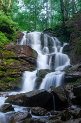 Obraz premium A stunning long exposure photograph of Shypit Waterfall in the Carpathian Mountains of Ukraine. The long exposure technique creates a smooth, silky effect on the cascading water