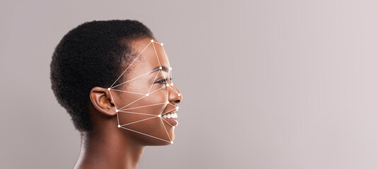 A joyful person with short hair is captured in profile, highlighting facial recognition technology...