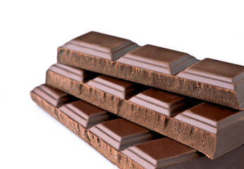Chocolate bars stacked neatly on a white surface for an appealing presentation