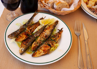 Portion of fried sardines served with lemon, typical dish of Spain