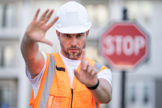 Construction worker with stop sign. stop sign or paddle used for traffic control by crossing guards, police or work zones. Construction area warning sign, stop hand safety