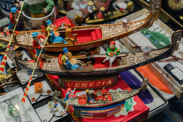 Souvenir from Venice. A floating gondola with people. © liukovmaksym