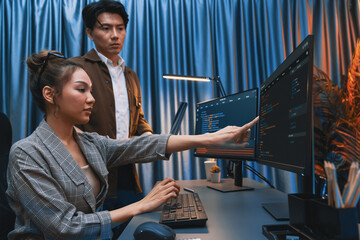 IT developers discussing with point to intelligent website development coder system running data...
