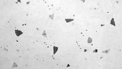 A white background with black and grey pieces scattered all over it. The image has a rough and...