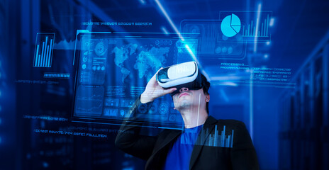 Businessman with headset standing at data center while analyzing financial data. Manager looking marketing statistic hologram and using augmented reality goggles while making a decision. Ingenuity.
