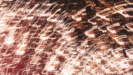 The image is a blurry, abstract representation of a cityscape at night. The streaks of light and...