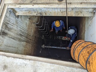 Workers Inside a Tank