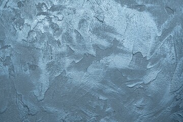 The texture of a concrete wall with anthracite and blue decorative plaster. Abstract background with place for text