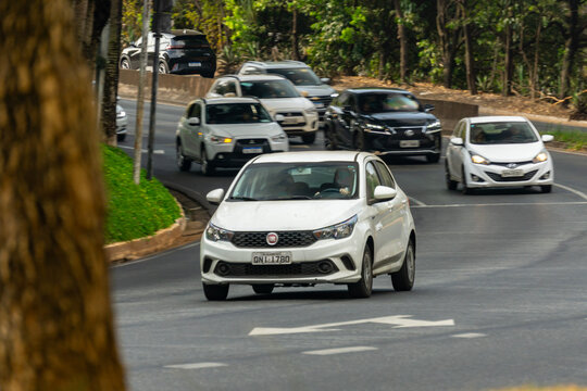 WhiteFiat Argo cruising city street, Compact hatchback in movement