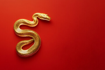 Fototapeta premium Gold snake on a red background for Chinese New Year concept