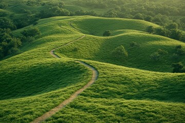 Obraz premium Serene landscape of rolling green hills with a meandering path inviting nature s embrace