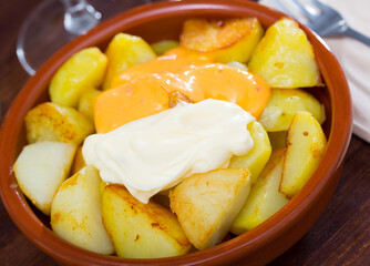 Plate of traditional Spanish tapas - Patatas Bravas with sauces