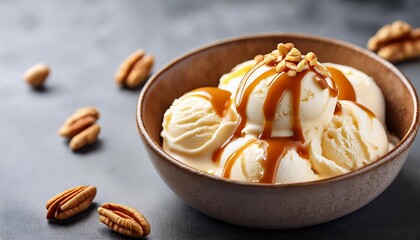 closeup of vanilla ice cream caramel sauce and nutsin in a bowl