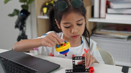 STEM education concept. Asian home school girls self-study online lessons and are excited to make STEM toys. mathematics engineering science technology computer code in robotics for kids' concepts.