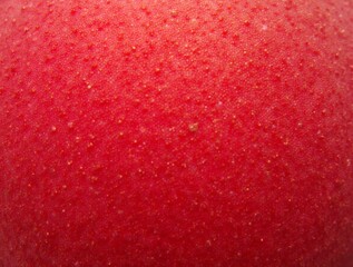 Close-up view of a pomegranate s vibrant red skin, showcasing its textured surface.
