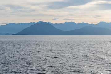 clouds over Strait of Georgia blue sky water landscape mountains on the horizon British Columbia Canada