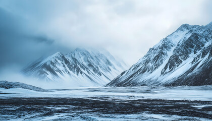 Frozen mountain landscape. A cold and desolate frozen landscape with snow-capped mountains and a snowstorm approaching