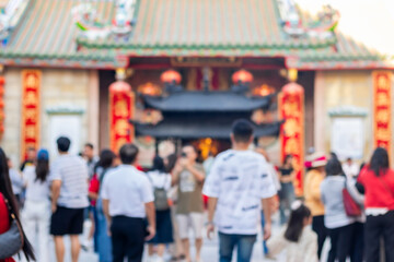 Blurred Photo of people make merit and pay respect to Buddha Dragon Temple Kamalawat is famous in Chinatown Bangkok, Thailand.