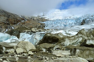the sermeq glacier and glacial melt at the end of the tasermuit fjord on a sunny summer day near...