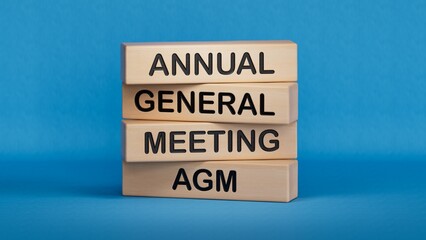 AGM - Annual general meeting symbol. Concept word AGM on wooden cubes. Business and AGM concept. Copy space.3D rendering on blue background.