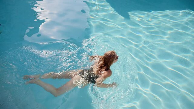 Enjoying a luxurious tropical vacation while swimming and relaxing in a stunning pool under the sun