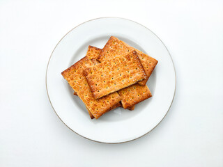 Stack of biscuits on a white plate isolated on a white background.