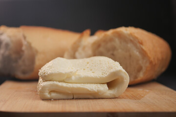 A delectable presentation of creamy goat cheese arranged on a rustic wooden cutting board