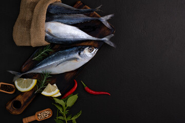 Raw mackerel, seafood, ready to cook on black background