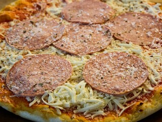 Frozen pizza. Close-up of a delicious pepperoni pizza with cheese.