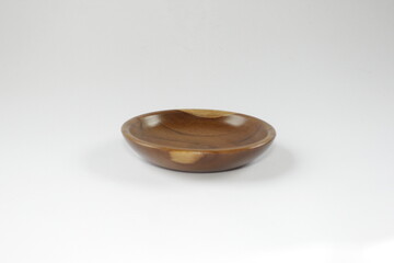 Wooden saucer or small wooden plate on a white background.