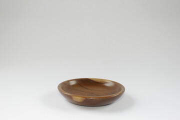 Wooden saucer or small wooden plate on a white background.