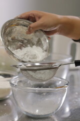 Pouring Flour: Preparing to Sift into a Glass Bowl